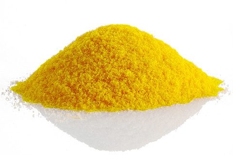 Yellow Explotracer powder on white surface.